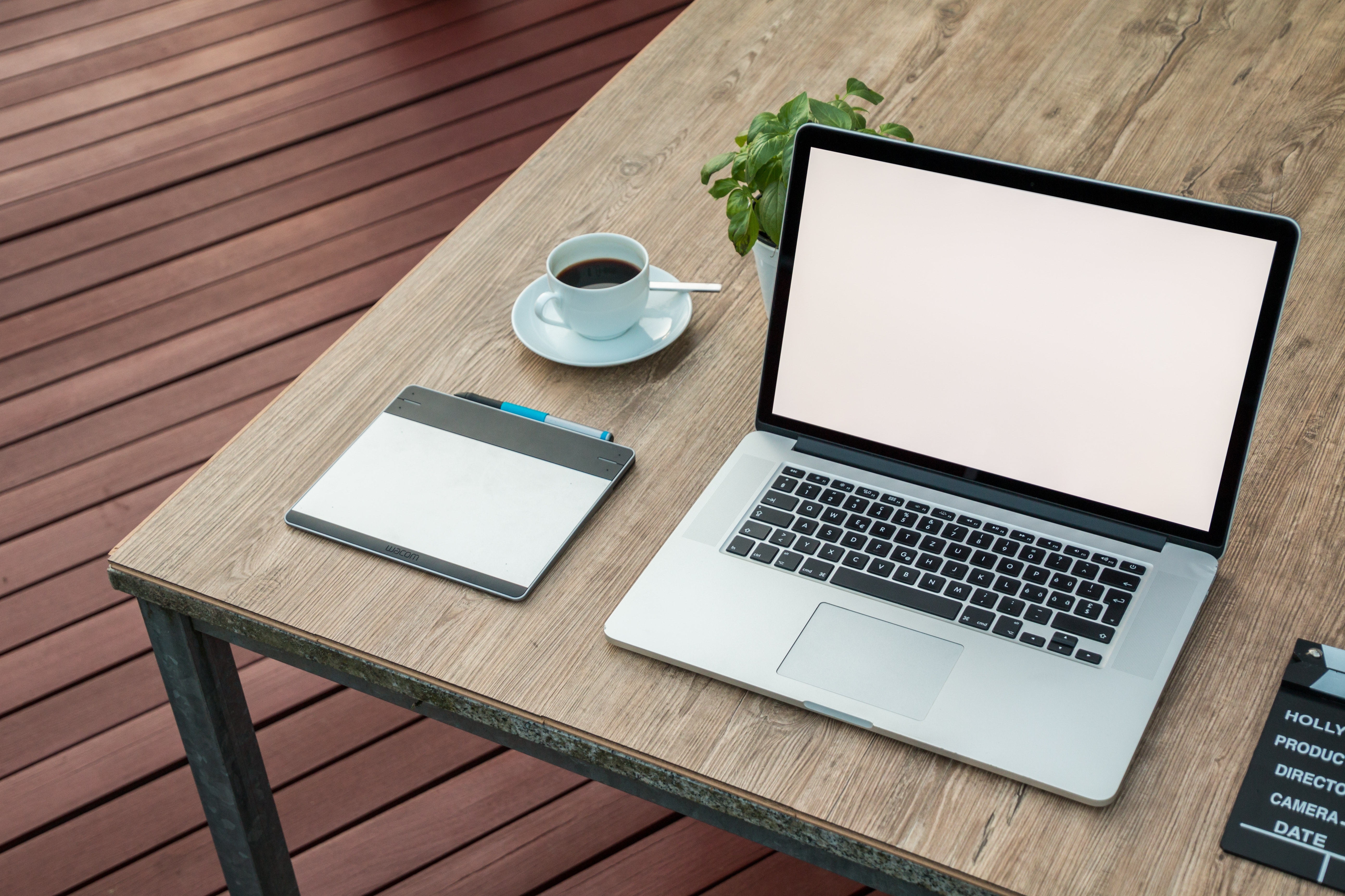 A Laptop on a table with a coffee